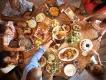 Overhead view of a family enjoying a shared, bountiful meal at a Table-Service restaurant at Walt Disney World.