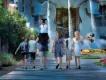 A family walking toward the Swan and Dolphin Resort fountains at Walt Disney World.
