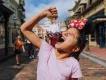 Guest on Main Street, U.S.A. eating a snack