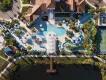 Aerial view of the resort pool complex, lazy river, and sports courts at Windsor at Westside