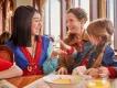 Mulan interacting with a mother and young girl during character dining at The Regal View Restaurant & Lounge