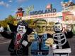 Three costumed Lego Halloween characters standing in front of the Legoland Windsor Resort entrance