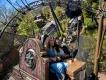 Two women smiling while riding the Curse of the Werewolf roller coaster