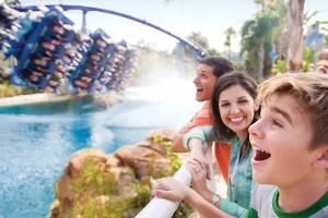 Boy watching guests riding Manta rollercoaster at SeaWorld Orlando