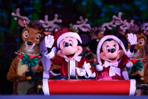 Mickey and Minnie dressed as Mr and Mrs Claus sitting in a sleigh