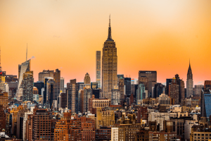 Buildings in New York with the Empire State Building in the centre, during sunset