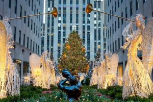 Glowing angel decorations in front of the Rockefeller Center Christmas Tree
