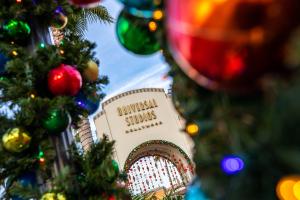 The Universal Studios Hollywood entrance decorated for Christmas with garlands and baubles