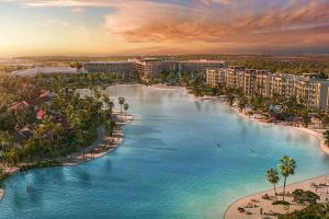Concept art of a hotel surrounding a beach and lagoon