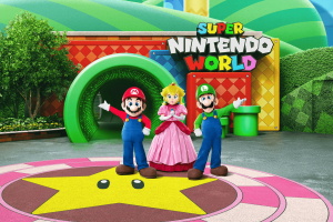 An artist rendering of Mario, Luigi and Princess Peach standing in front of the entrance to Super Nintendo World at Universal Studios Hollywood