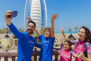 Family taking selfie in front of Burj al Arab, Wild Wadi Waterpark in Dubai