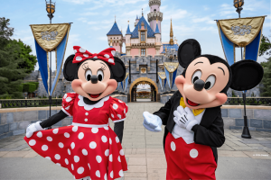 Mickey and Minnie Mouse posing in front of Sleeping Beauty Castle at Disneyland Resort 
