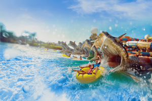 There are 6 slides ending up in a pool which end with people zooming out of an open snake's mouth statue. Everyone is sat in either a single or a double rubber ring.