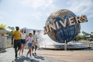 A family walking in front of the Universal globe at Universal Orlando Resort