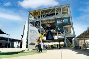 A woman and young girl standing in front of a rocket experience at Kennedy Space Center
