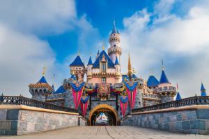 Sleeping Beauty Castle adorned with 70th anniversary flags and decorations