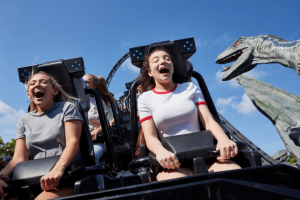 Guests laughing and screaming with excitement on the Jurassic World VelociCoaster at Universal Orlando Resort, one of the top attractions in Orlando.