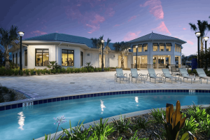 Lazy river and clubhouse with lounge chairs at Storey Lake Resort during dusk
