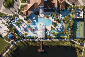 Aerial view of the resort pool complex, lazy river, and sports courts at Windsor at Westside