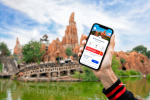A person holding a phone up with Disney Premier Access on the screen