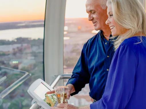 Couple enjoying champagne on the Icon Orlando Wheel