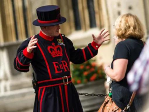 Guest listening to stories from the Beefeaters at Tower of London