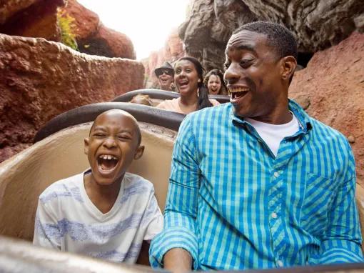 Father and Son on Seven Dwarfs Mine Train at Magic Kingdom
