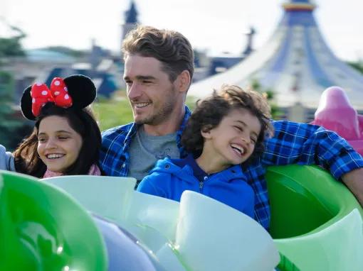 Family enjoying Dumbo the Flying Elephant ride at Disneyland Paris