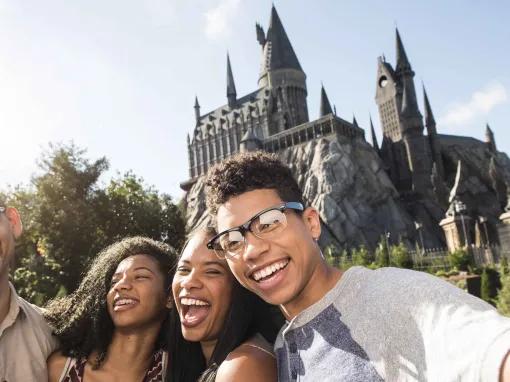 Family taking selfie in front of Hogwarts Castle at Universal's Islands of Adventure