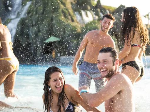 Guests playing on Watari Beach at Universal's Volcano Bay Water Theme Park