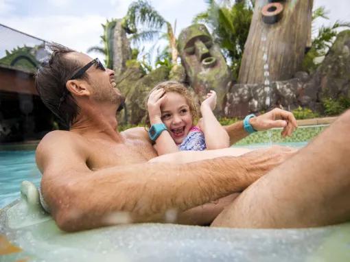 Father and daughter relaxing on Kopiko Wai Winding River at Universal's Volcano Bay Water Theme Park