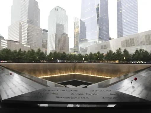 Names of victims of the 2001 and 1993 attacks inscribed into bronze panels surrounding the reflecting pools outside the 9/11 Memorial Museum