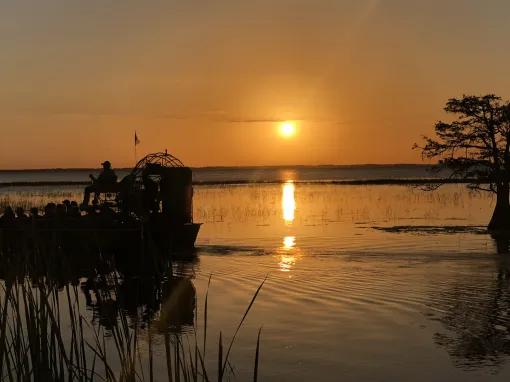 Guests enjoying a sunset airboat ride at Boggy Creek Orlando