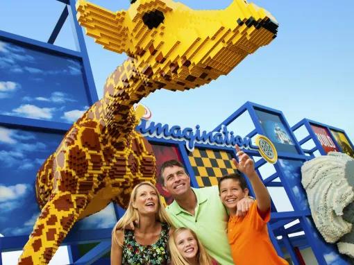 Family in front of LEGO giraffe at the entrance to the Imagination Zone at LEGOLAND Florida