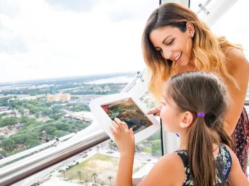 A lady and a young girl on the The Wheel at ICON Park™