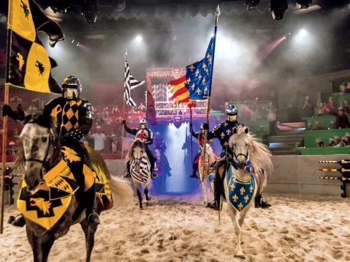 Knights riding horses in the arena at Medieval Times Orlando Dinner Show & Tournament