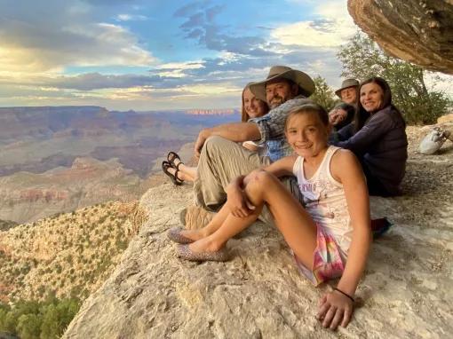 People sitting on the edge of the Grand Canyon 