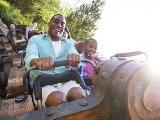 Guests riding Seven Dwarfs Mine Train at Magic Kingdom