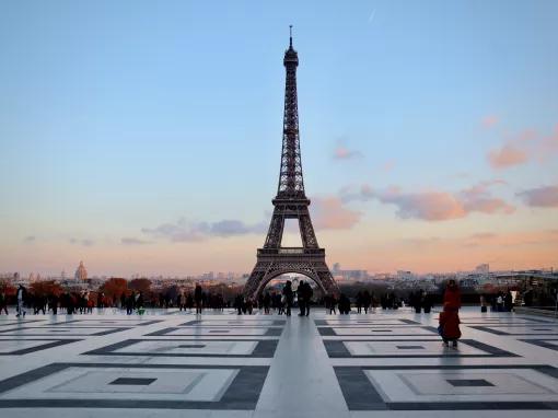 View of the Eiffel Tower from Trocadero Square with a pink and blue sky