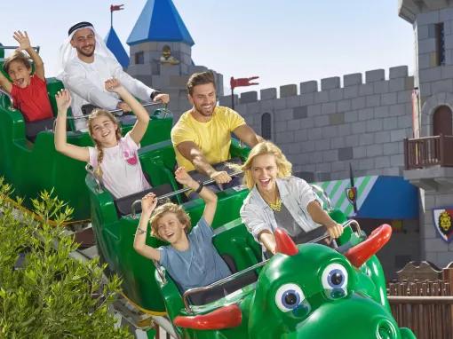 Guests riding the Dragon roller coaster at LEGOLAND Dubai