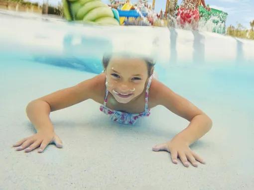 Girl swimming underwater at PortAventura Caribe Aquatic Park 