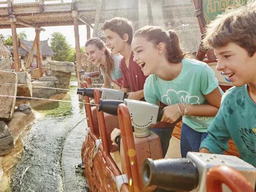 Guests using your water cannons to shoot at pythons on Angkor ride at PortAventura theme park
