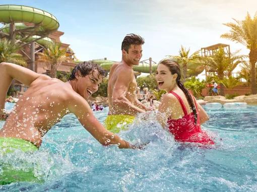 Adults splashing around in the lazy river at Aquaventure Dubai