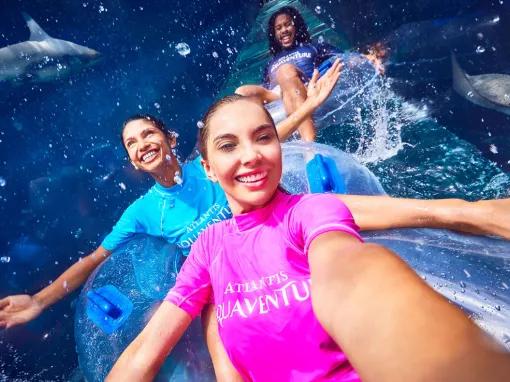 Friends riding Shark Attack waterslide at Aquaventure Dubai
