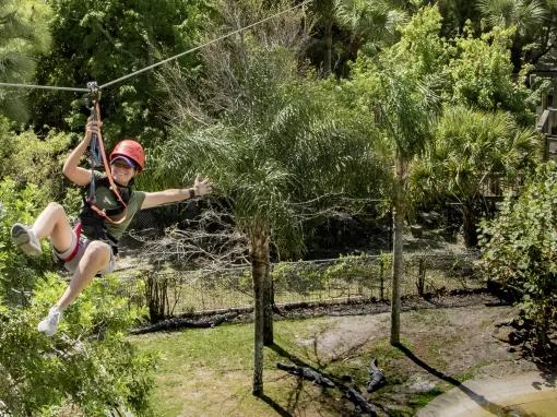 Woman riding the Gatorland Screamin’ Gator Zip Line