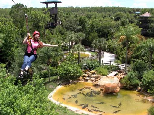 woman riding the Screamin’ Gator Zip Line at Gatorland