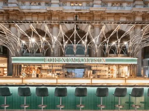 A jewel coloured bar lit up with gold accents featuring the name Fortum and Masons