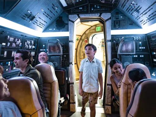 Boy in the Millenium Falcon cockpit, Star Wars: Galaxy’s Edge in Disneyland Park in California