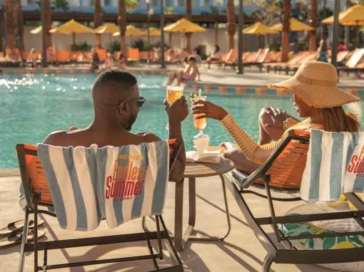 Guests have a drink next to the pool at Universal's Endless Summer Resort - Dockside Inn and Suites