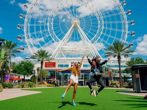 2 girsl in front of the ICON Park Wheel